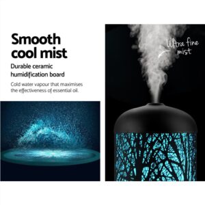 Essential oil diffuser emitting ultra fine mist with blue tree-branch light design; icons highlight ceramic humidification and cold water vapour