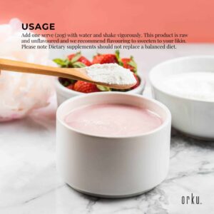 Orku supplement usage scene with wooden spoon holding white powder above ceramic bowl of pink liquid, background includes bowl of powder and dish of fresh strawberries, clean minimalistic setting emphasizing health and nutrition