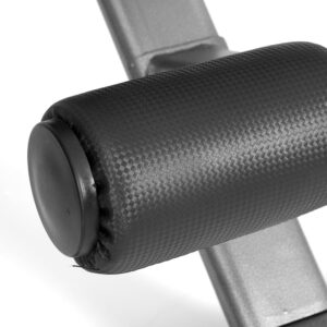 close-up of black textured cylindrical roller mounted on silver steel frame, designed for leg support in gym equipment