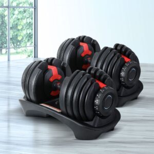 Pair of adjustable dumbbells with multiple weight plates and dial mechanism on storage tray for home gym strength training