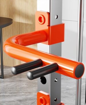 close-up of orange dip bar attachment with black grips mounted on vertical support of smartfit m1 max multi-station gym equipment