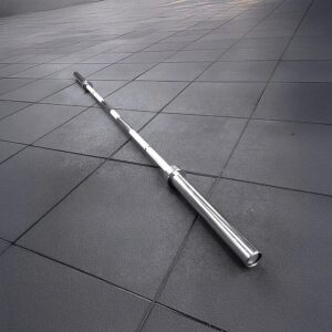 Olympic 7ft 20kg barbell with knurled grip and rotating sleeves resting diagonally on a tiled gym floor