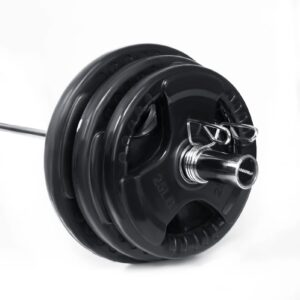 Olympic weight plates mounted on a barbell sleeve with spring collars for secure strength training and home gym workouts