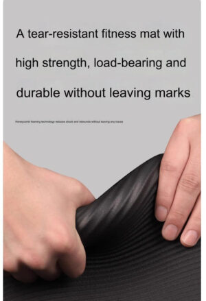 Close up of a black extra wide fitness mat showing flexible tear resistant high density foam construction designed for durability, cushioning and floor workouts