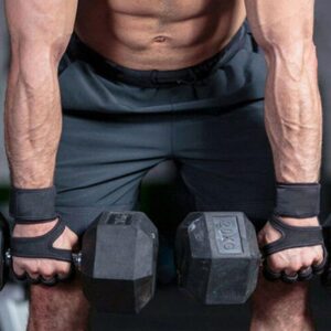 Athlete using weight lifting gloves with wrist support while performing dumbbell exercises during strength training workout