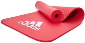 Adidas 7mm red fitness mat with cushioned textured surface for yoga, pilates, stretching and home workouts
