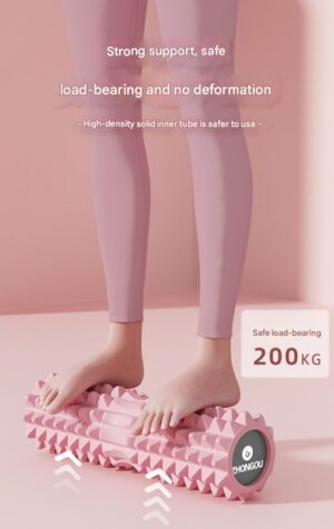Pink textured foam massage roller shown under a person’s feet, demonstrating durability and stability during use. The roller features a raised geometric surface for deep tissue massage. The background is soft pink, and visible text reads “Strong support, safe load-bearing and no deformation” and “High-density solid inner tube is safer to use.” A label indicates “Safe load-bearing 200KG,” highlighting its strength and resistance to deformation under pressure.