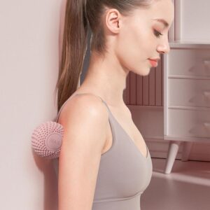 Textured massage ball being used on the shoulder against a wall to release muscle tension, improve mobility and support recovery training