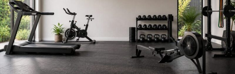 Modern home gym featuring cardio equipment including treadmill, exercise bike and rowing machine