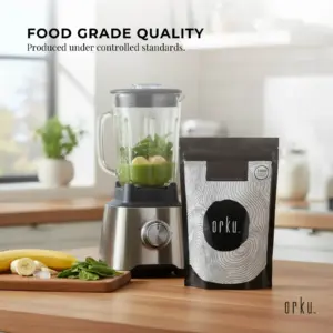 Orku food grade quality supplement powder beside a blender with green smoothie ingredients in a modern kitchen
