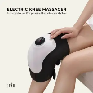 Person wearing the black and white Orku knee massager on their knee.