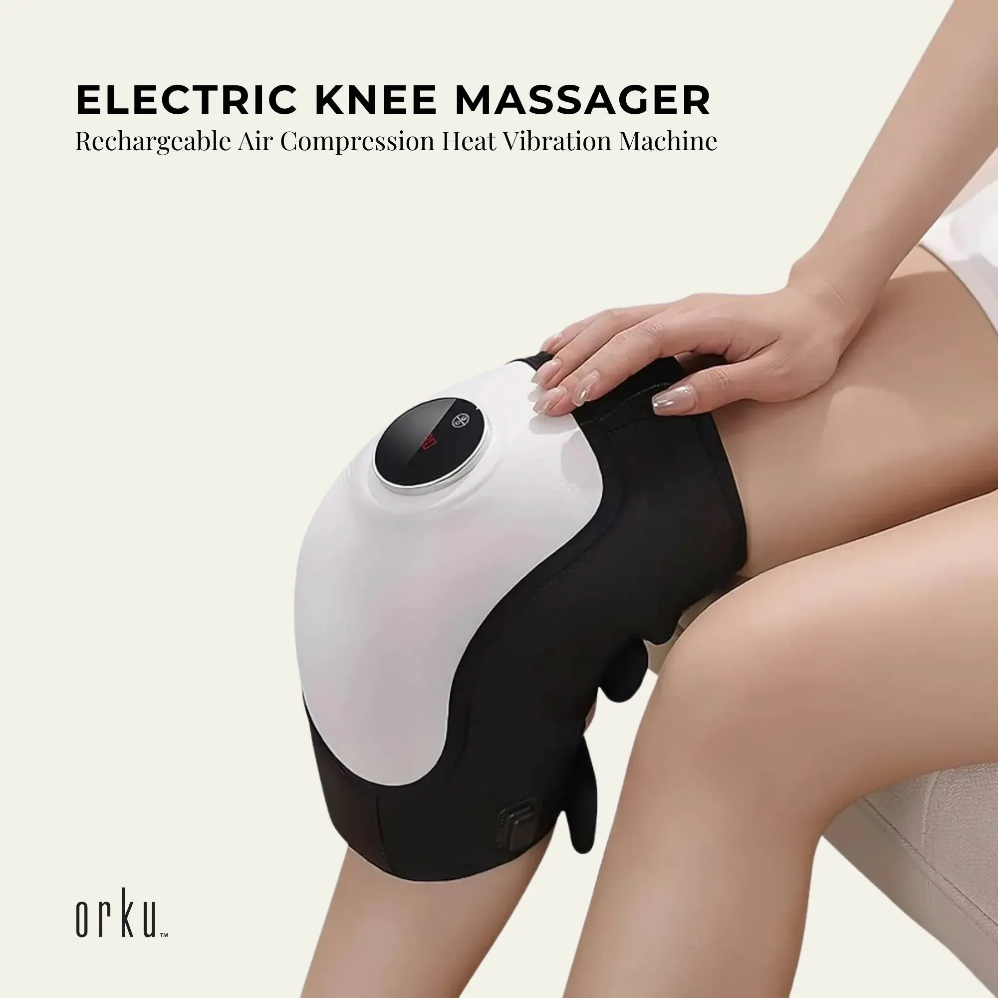 Person wearing the black and white Orku knee massager on their knee.