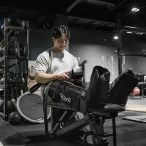 Person using ReGen8 Nyx compression boots during gym recovery