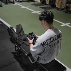 Person operating ReGen8 Nyx compression boots controller during a session