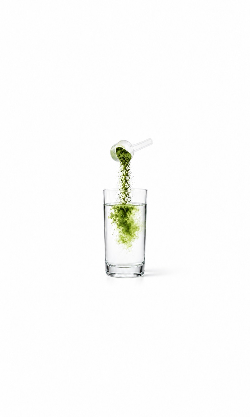 Green powder being poured from a scoop into a glass of water