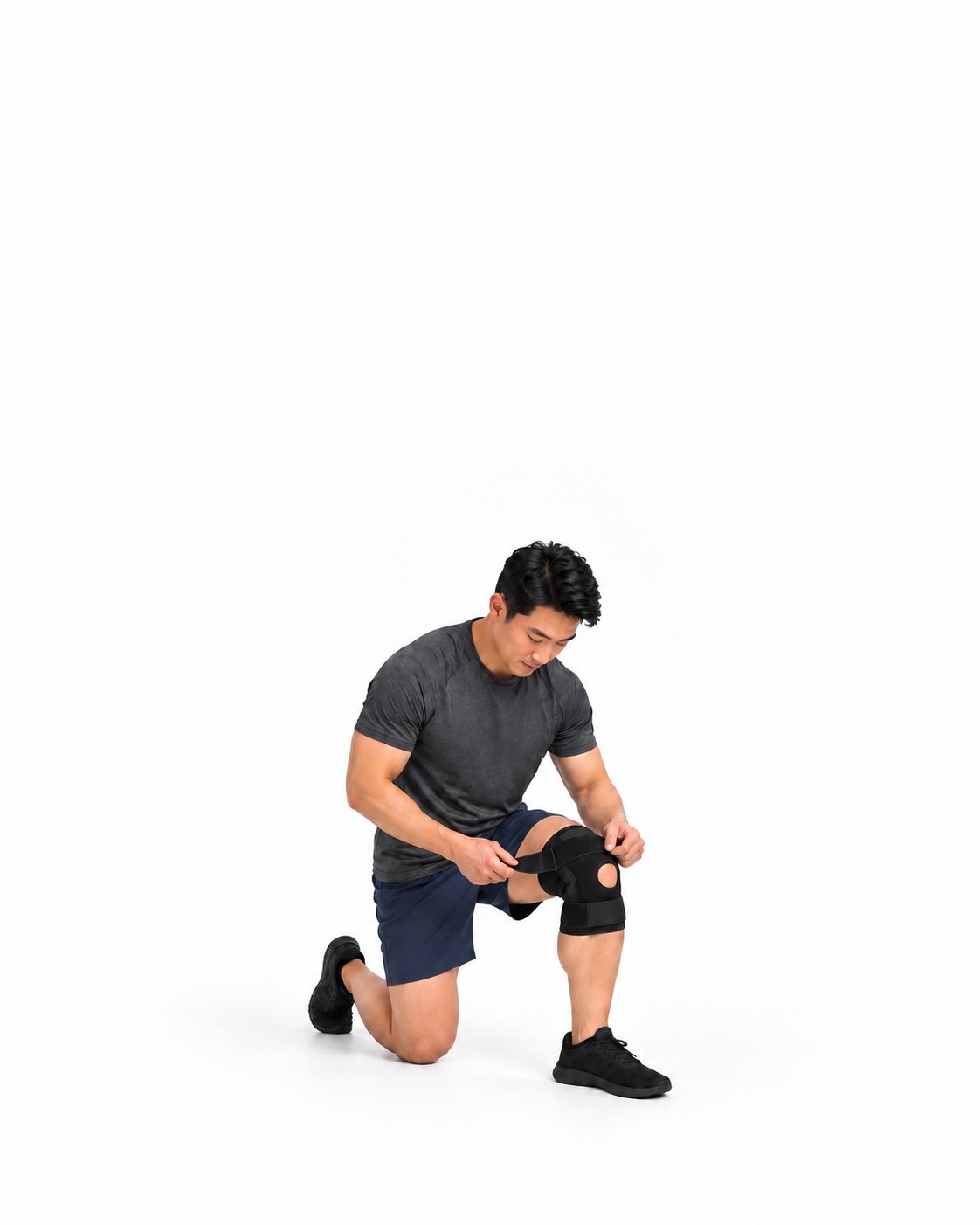 Man kneeling while fastening a black knee brace